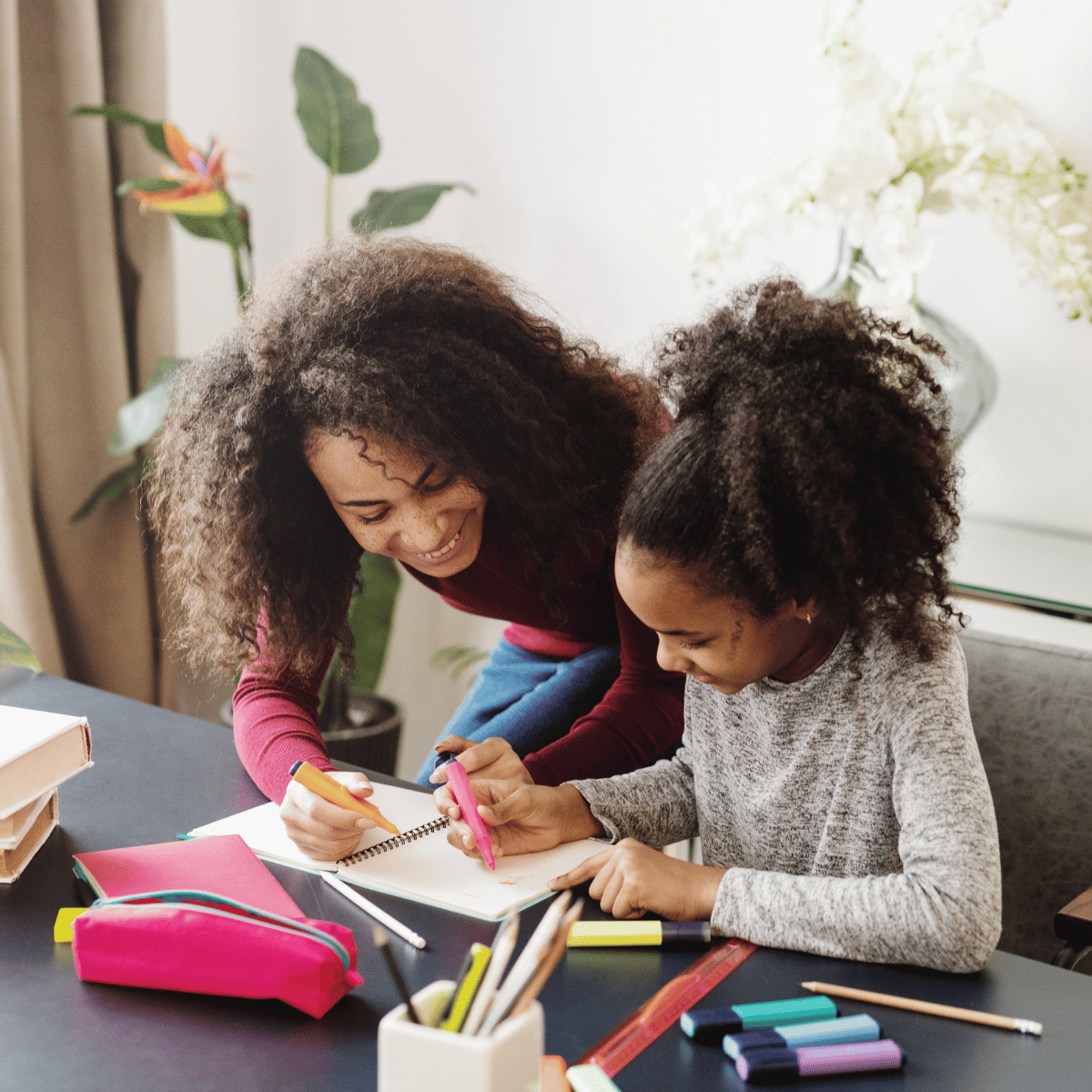 mom and daughter at table doing schoolwork