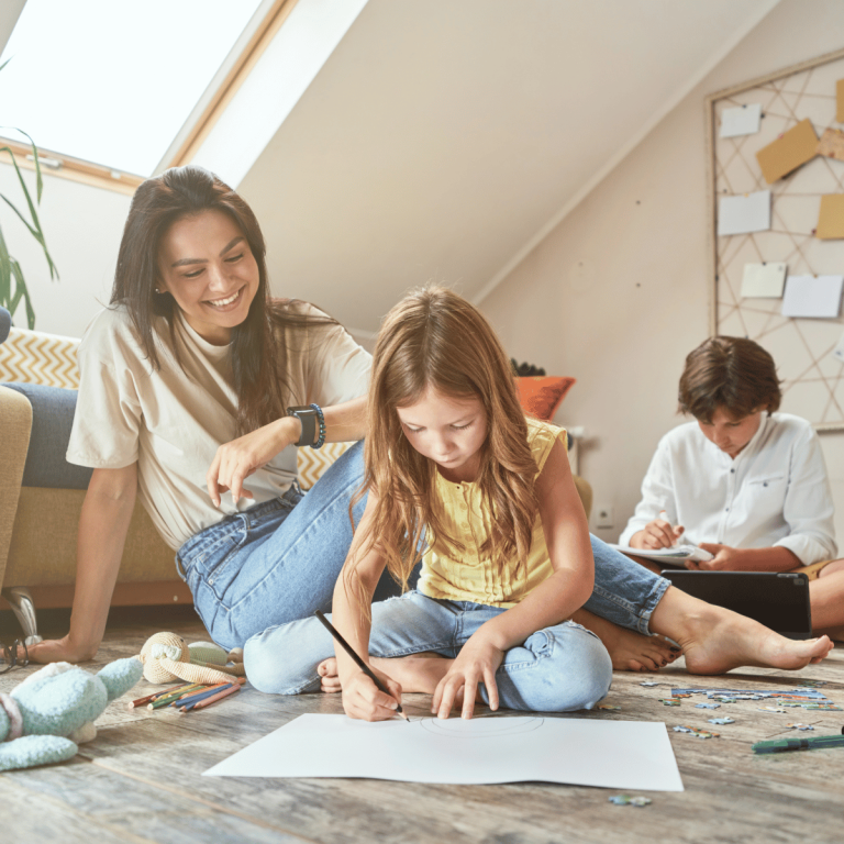 mom and kids on floor doing schoolwork