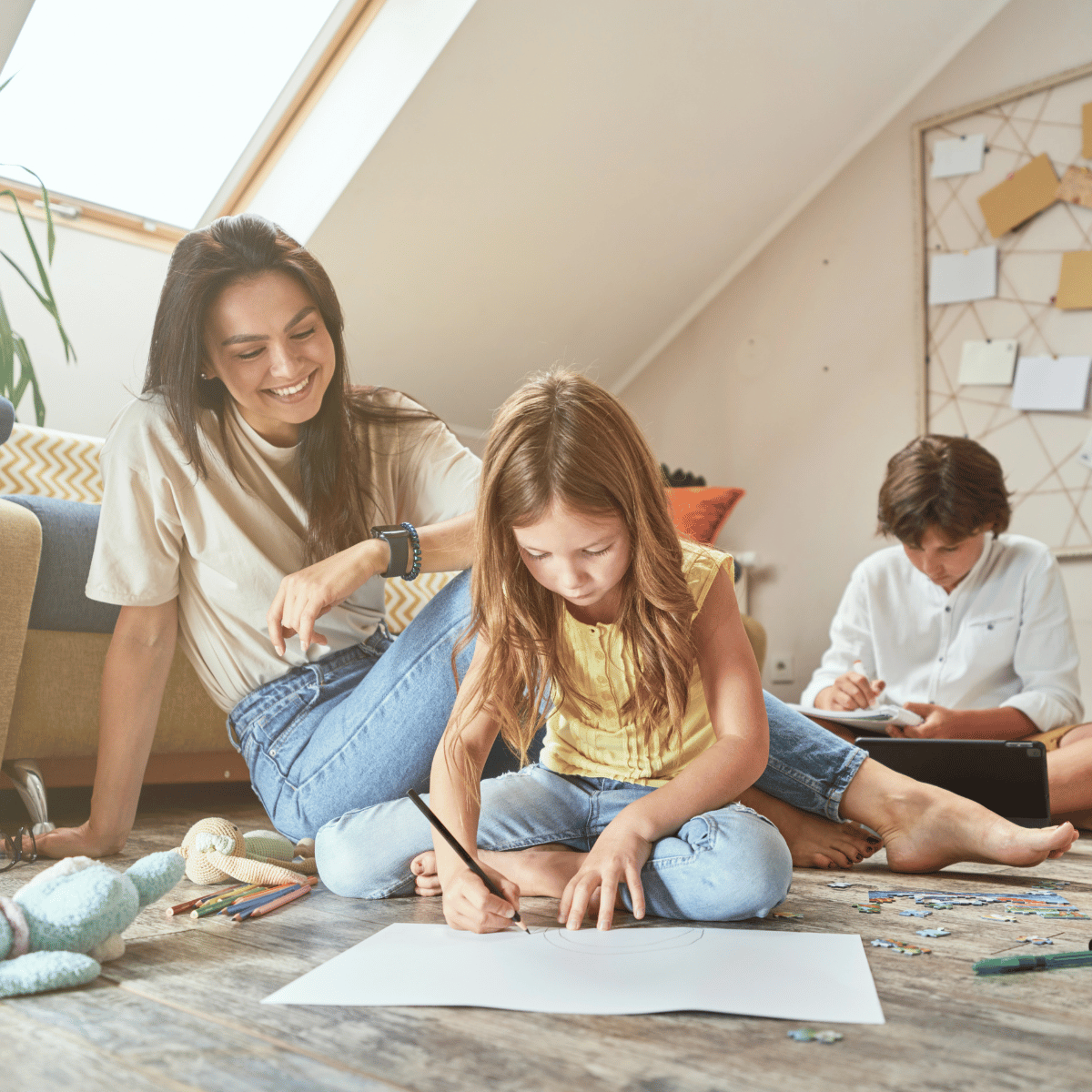 mom and kids on floor doing schoolwork