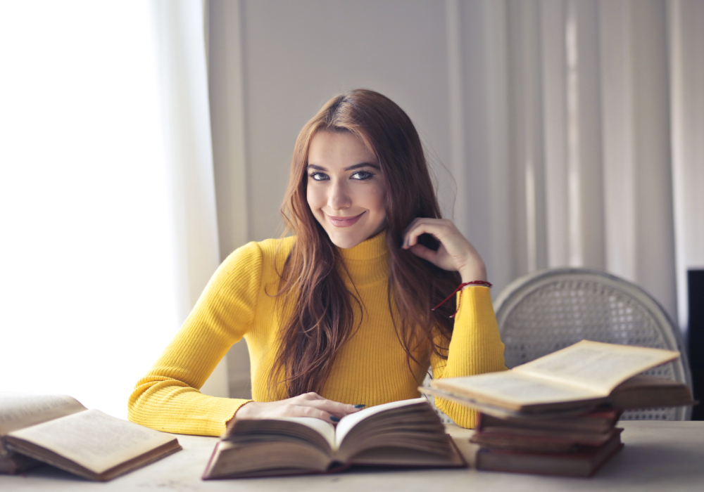 woman in front of books looking at camera