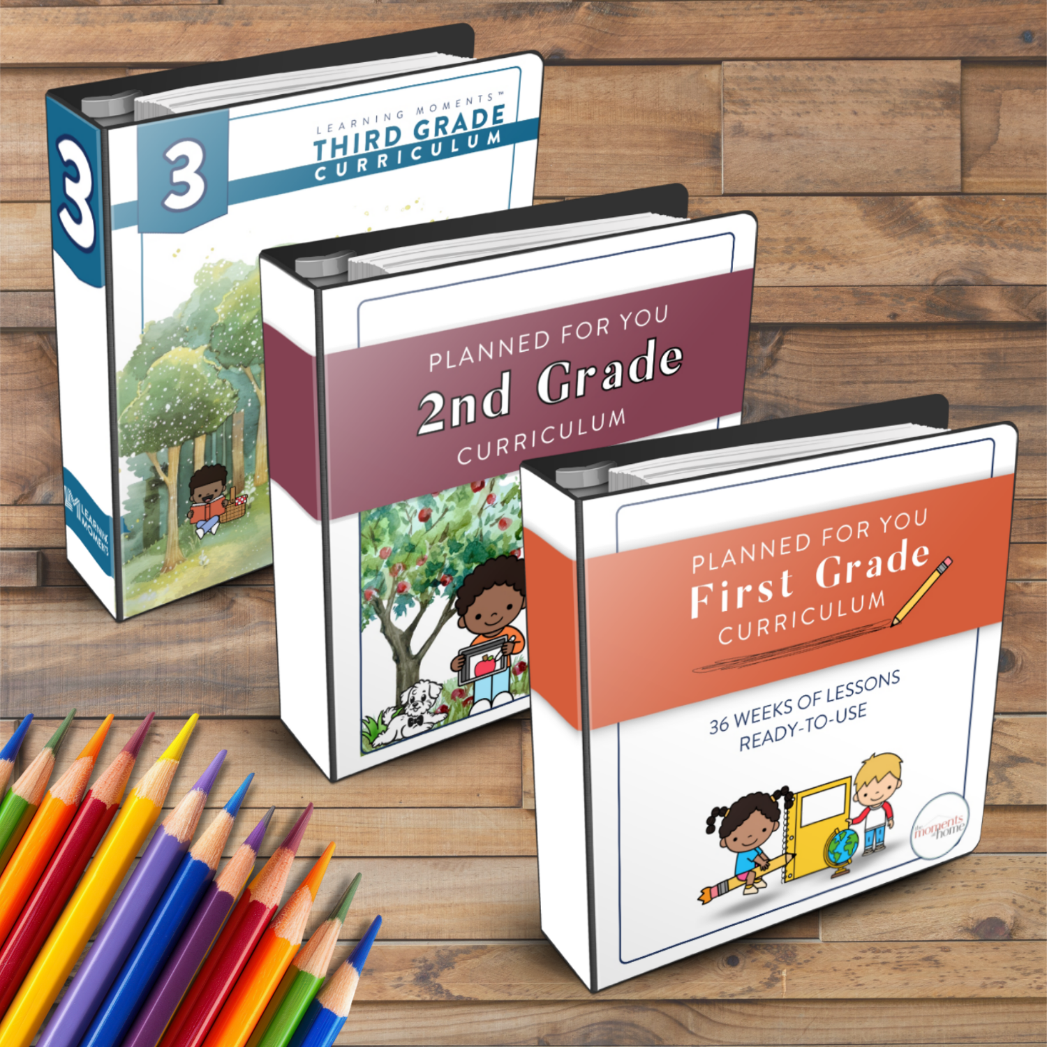 mockup of first grade, second grade, and third grade curriculum printable products in binders on a wooden background with school supplies